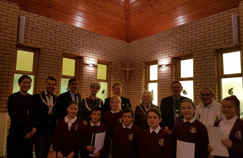 David Rutley MP with, front row, pupils from Christ the King Catholic and Church of England Primary School, and, back row (l-r), Mrs Heather Schofield, Cllr Adam Schofield, Cllr Liz Durham, Ms Lynn McGill, Cllr Lesley Smetham, Mr David Smetham, and Father Peter Cryan