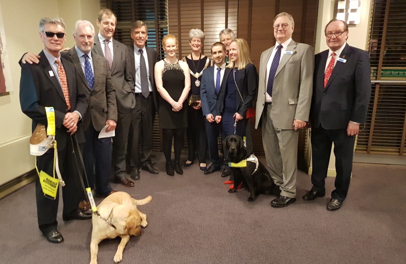 David Rutley MP with, l-r, Dave Thomas and guide dog Hannah, Paul Fletcher MBE, Alastair Campbell, Sophie Thornhill MBE, Councillor Liz Durham (Deputy Mayor of Cheshire East), Neil Fachie MBE, Richard Durham (consort to Deputy Mayor of Cheshire EAST), Lora Fachie MBE and guide dog Tai, Ray Kramer (Chairman of East Cheshire Eye Society) and Phil Spring, Trustee of East Cheshire Eye Society