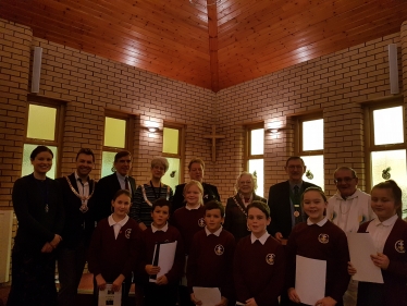 David Rutley MP with, front row, pupils from Christ the King Catholic and Church of England Primary School, and, back row (l-r), Mrs Heather Schofield, Cllr Adam Schofield, Cllr Liz Durham, Ms Lynn McGill, Cllr Lesley Smetham, Mr David Smetham, and Father Peter Cryan